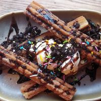 Churros 🤤 covered in chocolate sauce, oreo crumb & sprinkles served with Vanilla ice cream at Rabbit Food @ Meadows Tap in Edinburgh