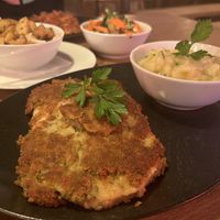 Vegan ‘celery’ schnitzel with potato salad, roast potatoes and hot vegetables   at HeimWerk Tal in Munich