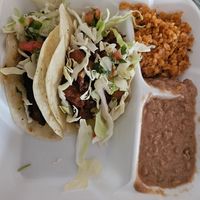 Taco plate (Califlor taco and champignones pibil taco) with beans and rice. at Tanias 33 Dos Mundos in Tucson