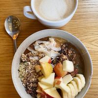 Vegan “ALL IN” toppings porridge and oat milk cappuccino  at Grød - Christianshavns in Copenhagen