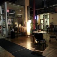 View from the booths towards front door and area with mic. at Downtown Central Perk in Davenport