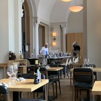 Grand, high ceilings, pizzas cooked in wood-burning oven  at Più Zug in Zug