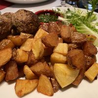 Bean balls and potatoes as a side with chimichurri sauce and salad  at Black Dog in Paris