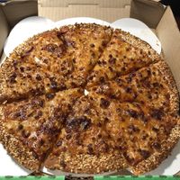 Perfectly done vegan cheese pizza with a cauliflower crust and sesame seeds   at Red Swan Pizza in Regina
