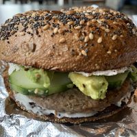 Harvest Grain bagel with vegan cream cheese, vegan breakfast sausage, avocado and cucumber  at Tandem Bagel Company in Florence