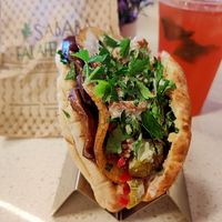 Amazing falafel pita wrap. I had it with fried veggies added and hibiscus lemonade. at Sababa Falafel Shop in Garden Grove