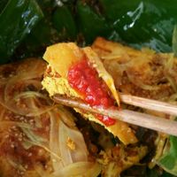 Stuffed tofu w onion, mashrooms, garlic and curry rolled in banana leaf and steamed (have a bit of a sweet flavor)  at Minh Hien in Hoi An