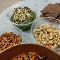 Avocado dip, sprouted wheat and sweet pea, and crackers at UMMY - უმმი in Tbilisi