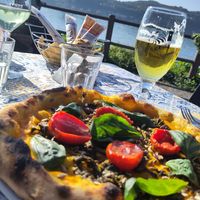 Pizza Girasole with pumpkin cream, half dried tomatoes, friarielli kale, Ligurian olives, fresh basil  and sunflower seeds at Pizzeria Damino in Angera