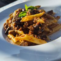 Penne alla Mediterranea, short pasta with pesto made from eggplant, sun-dried tomatoes, almonds, mint and fresh basil. at Pizzeria Damino in Angera