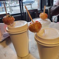 Hot drinks topped with doughnut holes at Dough Joy in Seattle