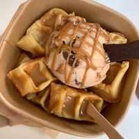 Bueno scoop with Lotus Biscoff sauce on waffle bites with edible spoon  at Plan(e)t Ice Cream in Athens