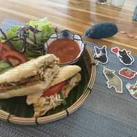 Vegan crispy tofu sandwich and some goodies you can buy to help feed the cats  at The Happy Cat - Veggie Cafe-Restaurant in Luang Prabang