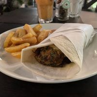 Vegan gyro (pita bread filled with hummus, zucchini fritters, lettuce, tomato, grilled onion) with fries, $5.50  at Elia Greek Kitchen Bassac Lane in Phnom Penh