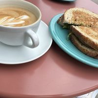 Oat milk latte and vegan sausage panini   at Origin Coffee in Saranac Lake