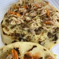 “Cheese” and loroco pupusa, “cheese” and veggies pupusa. Curtido (pickled cabbage and carrot) on top  at La Sabrosa Sweets in Los Angeles