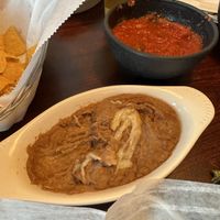 Vegan refried beans w vegan cheese on top  at Solazo in Jacksonville