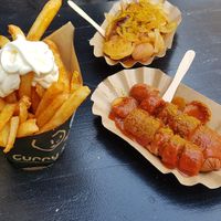 French fries with vegan mayonaise, currywurst classic style (front) and with onions (back) at Curry Co in Dresden
