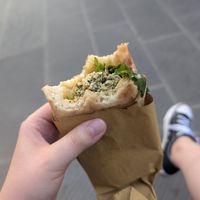 Flatbread with spinach tofu burger and vegetables at Vegan Come Koala in Pisa
