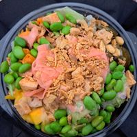 Avocado, mango, tofu, red onion, edamame, rice and salad mix (recommend rather than just rice, it's an awful lot) jalapeños and sweet potatoes, topped with crispy onions, pickled  at Hawaiian Poke Bowl in Bruges