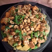 Mango, edamame, sweet potato, tofu, avocado, sushi rice, topped with sesame soy, spring onions and peanuts. Something else in there too but I can't remember, honestly the thing is  at Hawaiian Poke Bowl in Bruges