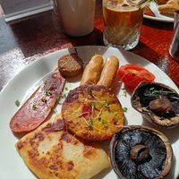 Plant-based Linen Hall breakfast (vegan bacon, sausages, white pudding, tomato, mushrooms, potato bread and a little vegan Spanish potato omelette) at Linen Hall Cafe in Belfast