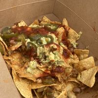 The bizness nachos hella size with vegan cheese and no crema (already 1/3 eaten)  at Nacho Bizness in Monterey