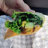 Falafel wrap (well, half of it) ☺️ at Black & White Cafe and Bakery in St Peters Bay