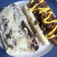 Vegan dogs- build your own. One with sauerkraut and the other with vegan chili and mustard   at Un Mundo Café in Springfield