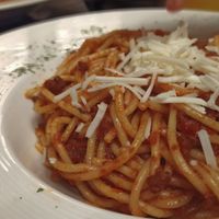Vegan spaghetti bolognese with vegan cheese at La Cibulina in Sant Feliu De Guixols