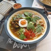 Spicy teriyaki chicken ramen with a vegan egg and side of kimchi   at Wagamama in Stoke-on-trent