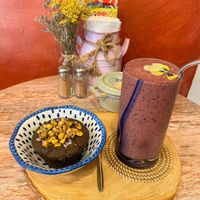 Pistachio cake & mango+red berries smoothie   at Indie Café and Concept Store in Cusco