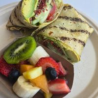 Gluten-free avocado wrap (with crunchy vegan bacon bits) with a side of fresh fruit at Jan's Health Bar in Huntington Beach