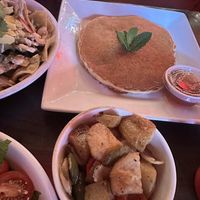 Vegan pancake side and home fries side , sit-down dining at Mekelburg’s  at Guevara's - Domino Park in Brooklyn