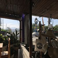 View from outside tables. Souvenir shop next door  at The Juice Bar by Bajo Bloom in 