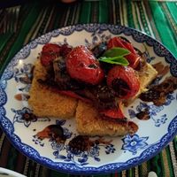 Chickpeas omelette (farinata) with confit tomatoes and basil at Green Life Market in Sarande