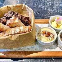 Bread bag with hummus, butter and zataar  at Pawdy Neighbors  in Dubai