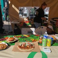 Market stall with displays of food options   at Vegan World in North London