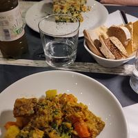 In primo piano: Spezzatino vegan di seitan molto buono! In secondo piano un risotto vegetariano con erbe varie, non il massimo, molto formaggioso at Osteria di Fuori Porta in Padua