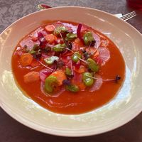 Starter: Soupe glacée de tomate, légumes croquants, févettes et olives Kalamata

Iced tomato soup with crunchy vegetables, fava beans and olives.
 at Le Parvis in Saintes