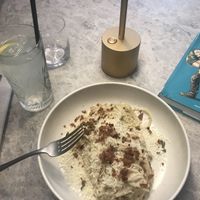 Vegan carbonara-style pasta with creamy cashew sauce, topped with vegan parmesan and bacon (+homemade lemonade!)  at Bistro Verde in Copenhagen