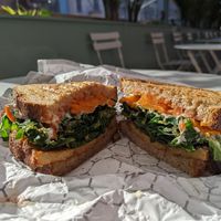 Autumnal sandwich with tempeh bbq bacon, kale, roasted sweet potato, aioli on sourdough at Clementine Bakery in Brooklyn