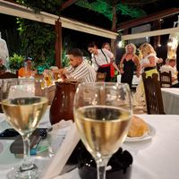 Carafe wine and dancing people at Taverna Vergina in Crete