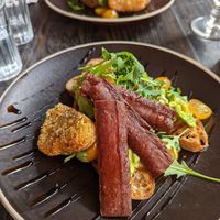 Avocado toast with vegan bacon and hash browns at Rising Café in Lincoln