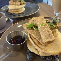 Oatly pancakes with blueberries and vegan sausages  at Arise Coffee Roasters in West London