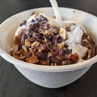Vanilla oat milk soft serve with chocolate sauce and almonds at Rad Radish in San Francisco