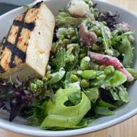 The Every Day Bowl topped with snap pea, potato + mint side, and chili lime tofu at Tractor Foods - Olympic Village in Vancouver