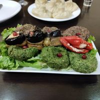 phkali platter and potato khinkali behind it at Khinkali House in Tbilisi
