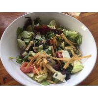 Thee Fighting Artichoke is artichoke hearts, palm hearts, kalamata olives, cucumbers, tomatoes, fresh greens with a creamy tahini lemon dressing with crunchy tortilla strips. Yum! at Green New American Vegetarian in Phoenix