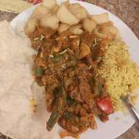 vegan garlic chilli veg curry with garlic pilau rice, a side of bhindi bhaji, chips and poppadoms at Spice Station in South Shields